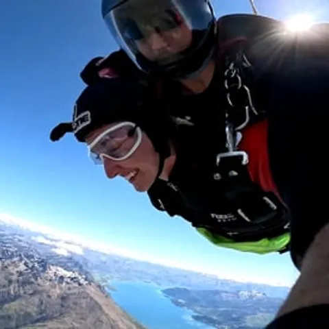 A tandem skydiver in freefall above Lake Wakatipu
