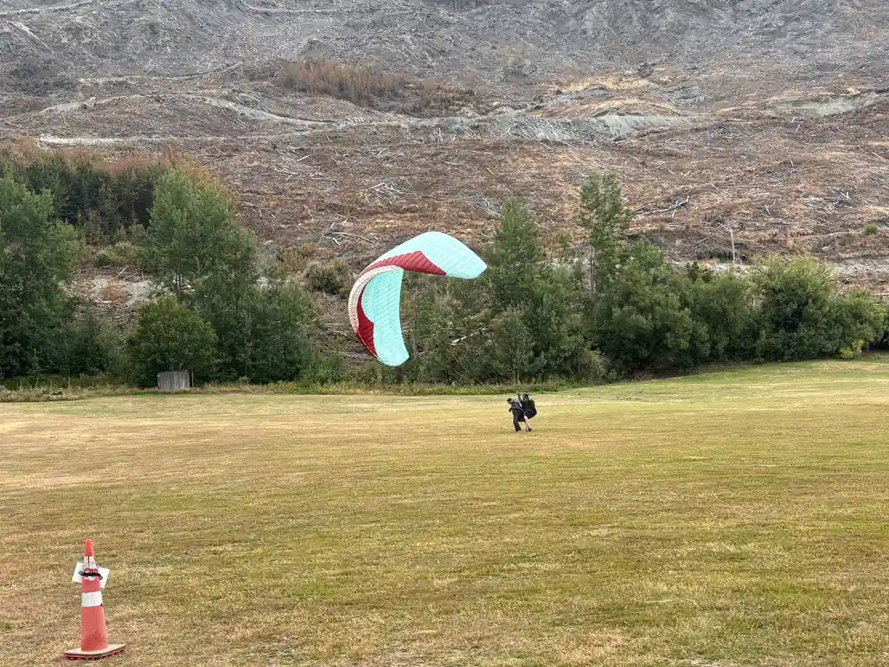 A canopy laid out on the grass of the landing field