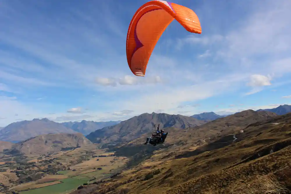 An orange canopy high above the mountains
