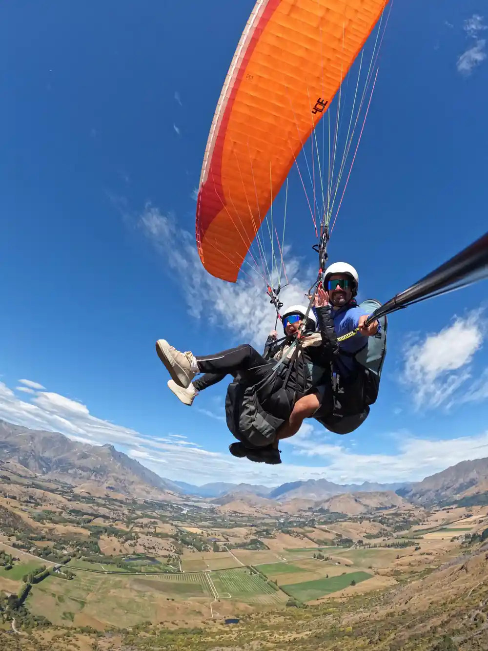 An orange wing above the valley, tandem below it