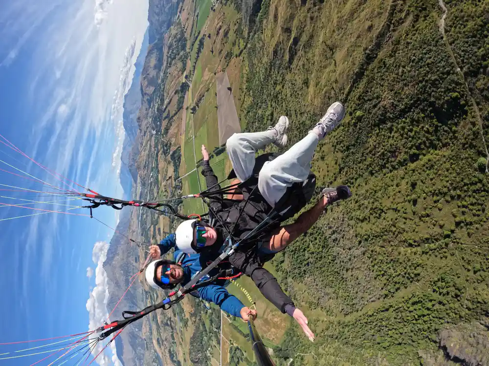 A tandem banked above the valley with the lake beyond
