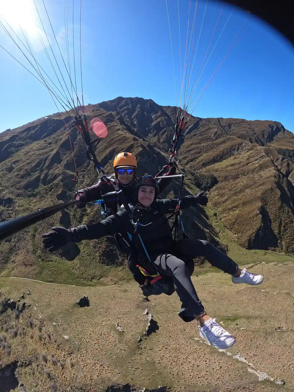 A tandem flight above a dark ridge line